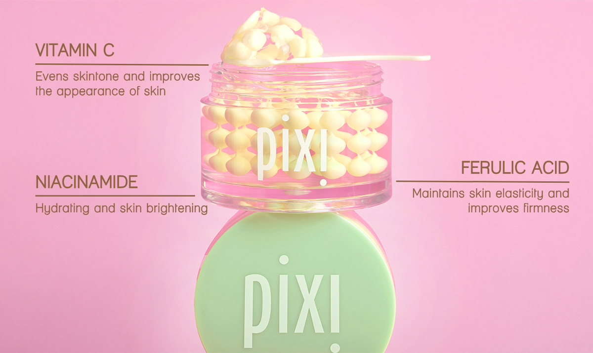 Pixi Vitamin C CremeSerum jar with a mint green cap and clear jar showing yellow serum, set against a solid pink background with text detailing the ingredients.