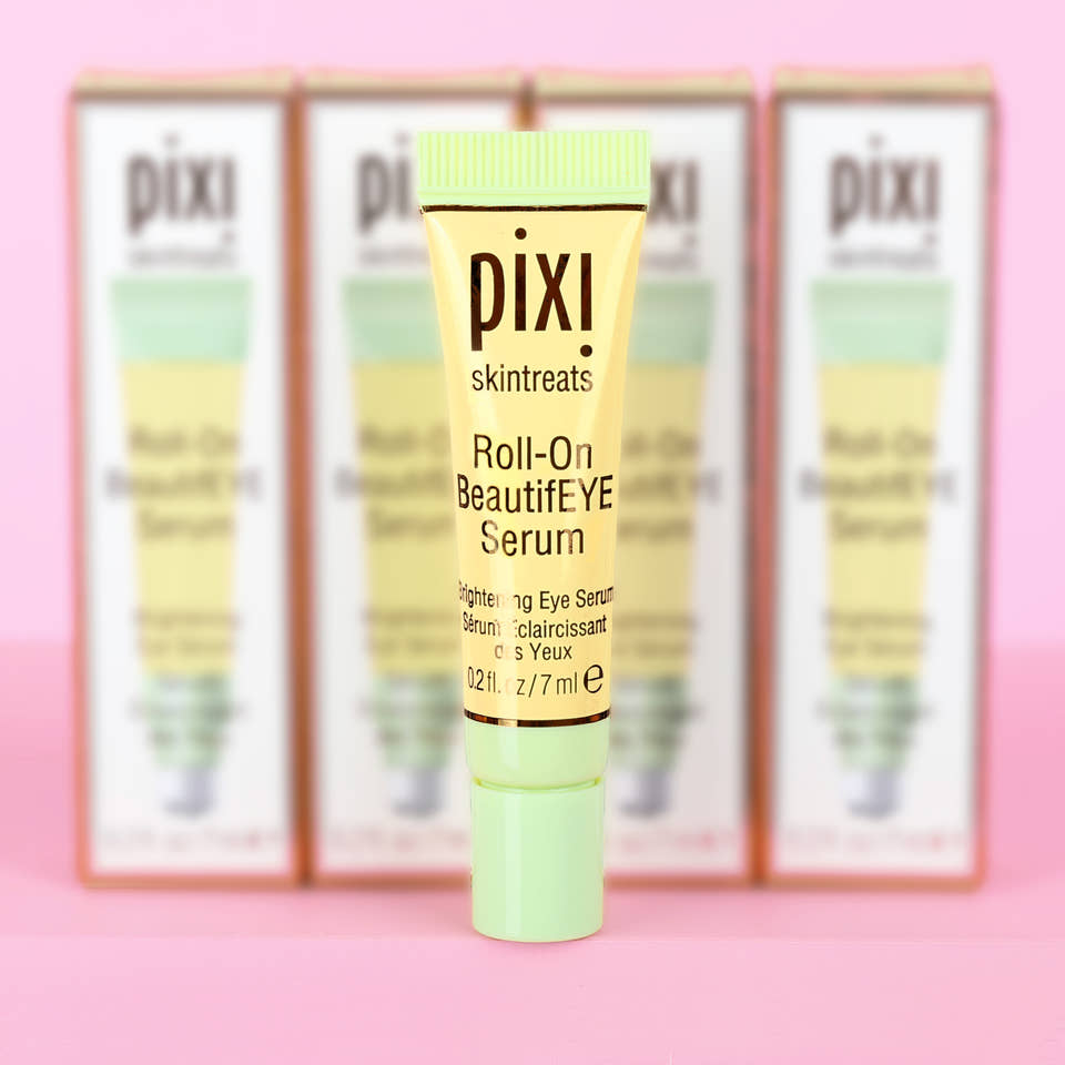 Pixi Skintreats Roll-On BeautifEYE Serum in Petite size - brightening eye serum shown with packaging in the background. view 1